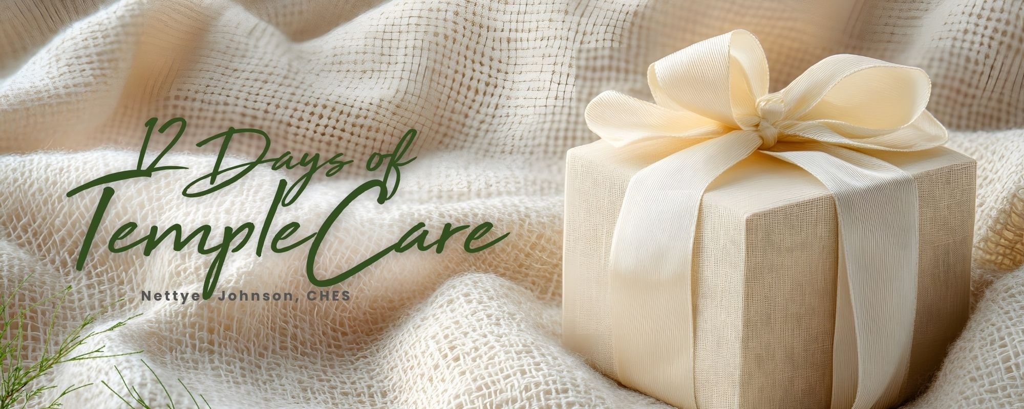 Soft cream blanket with a wrapped cream gift box tied with twine resting on top, creating a warm and peaceful holiday scene.